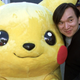 Pokémon Company president Tsunekazu Ishihara stands next to a person in a Pikachu costume.